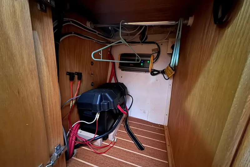 Slide: The Image of Electrical setup inside 2013 Eco-Trawler 33, featuring wiring and battery storage. - 42