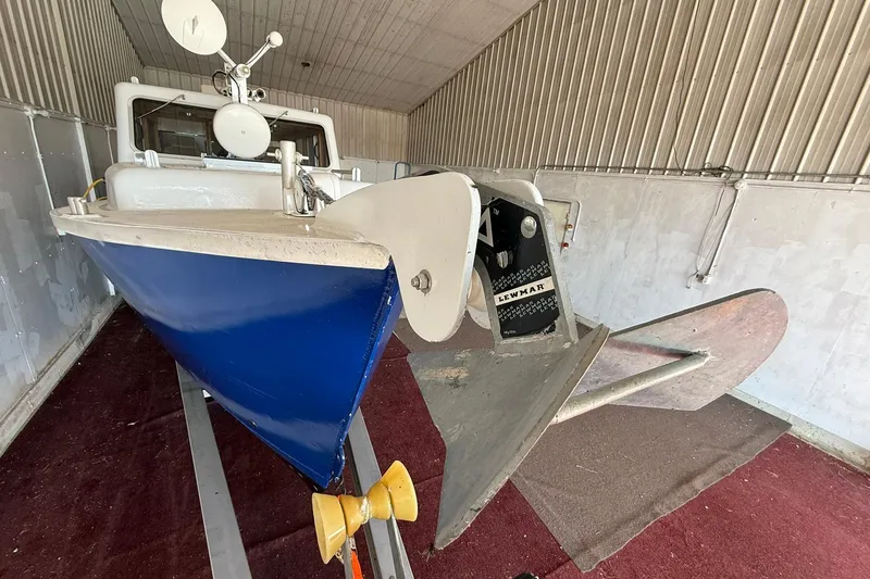 Slide: The Image of 2013 Eco-Trawler 33 in storage, featuring a blue hull and Lewmar equipment. - 7