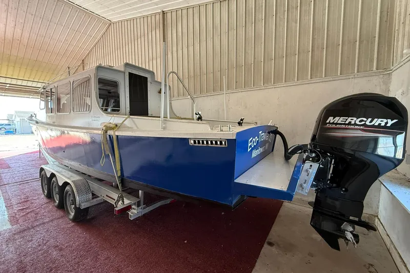 Slide: The Image of 2013 Eco-Trawler 33 boat with Mercury outboard motor in a storage facility. - 8