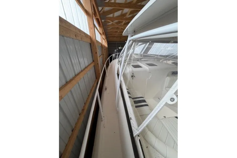 Slide: The Image of 2009 Intrepid 377 Walkaround boat stored in a wooden and metal structure. - 10
