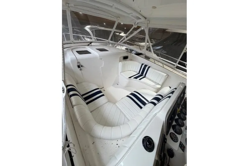 Slide: The Image of 2009 Intrepid 377 Walkaround boat interior with white and navy seating. - 12