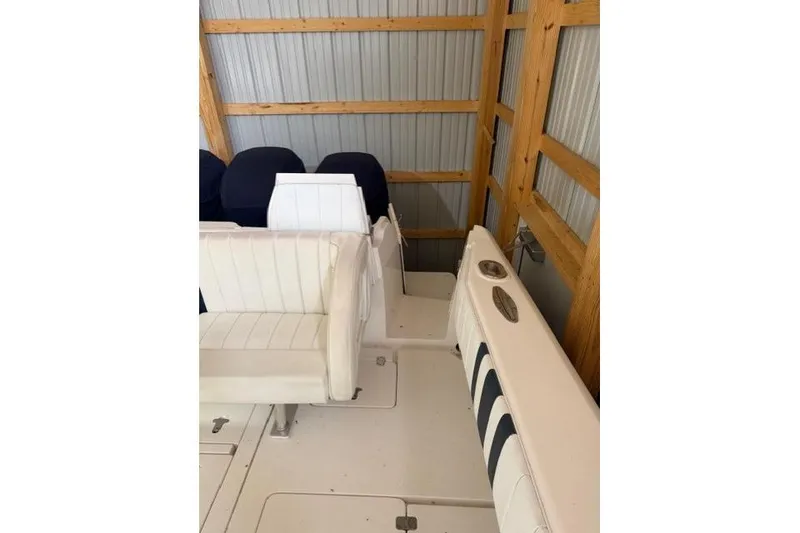 Slide: The Image of 2009 Intrepid 377 Walkaround boat interior with white seating in a wooden storage area. - 13