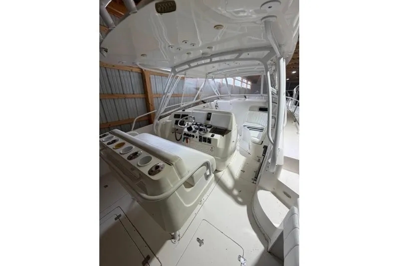 Slide: The Image of 2009 Intrepid 377 Walkaround boat interior with helm and seating area. - 14