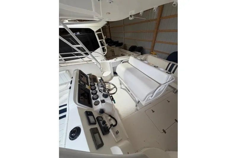 Slide: The Image of 2009 Intrepid 377 Walkaround boat interior with helm controls and seating. - 15