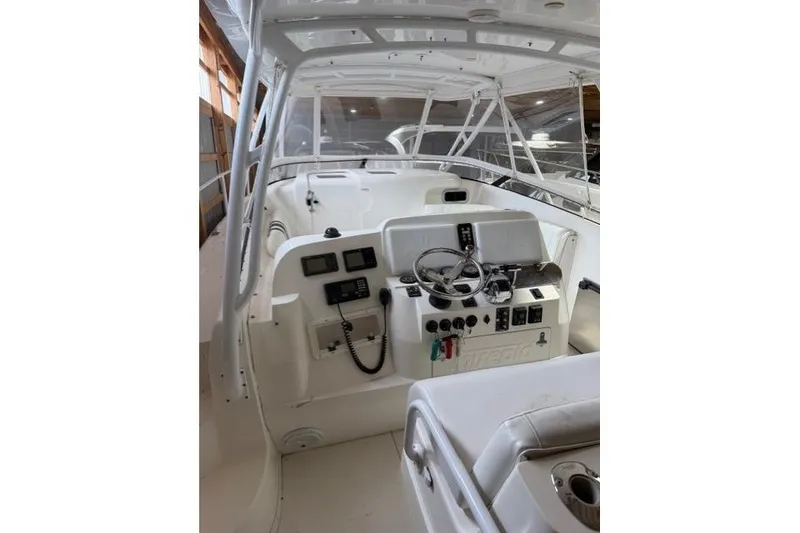 Slide: The Image of 2009 Intrepid 377 Walkaround boat interior with steering wheel and control panel. - 17