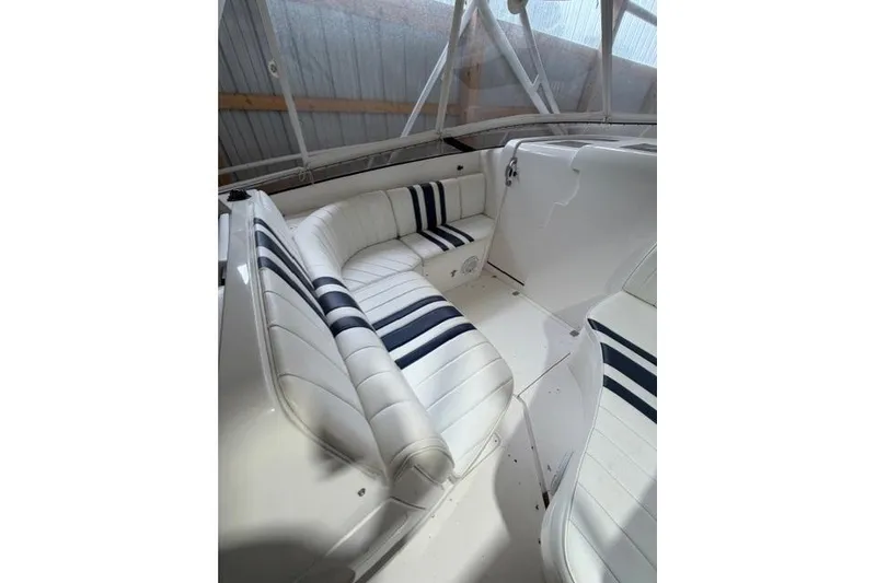Slide: The Image of 2009 Intrepid 377 Walkaround boat interior with white and navy striped seating. - 18