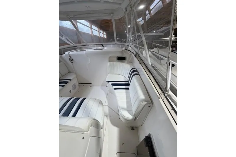 Slide: The Image of 2009 Intrepid 377 Walkaround boat interior with white seating and striped cushions. - 19