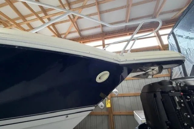 Slide: The Image of 2009 Intrepid 377 Walkaround boat in storage, showcasing sleek design and powerful engine. - 2