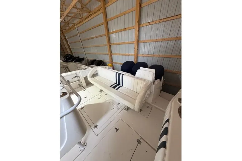 Slide: The Image of 2009 Intrepid 377 Walkaround boat interior with white seating in storage. - 21