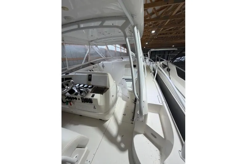 Slide: The Image of 2009 Intrepid 377 Walkaround boat interior with helm and seating area. - 22