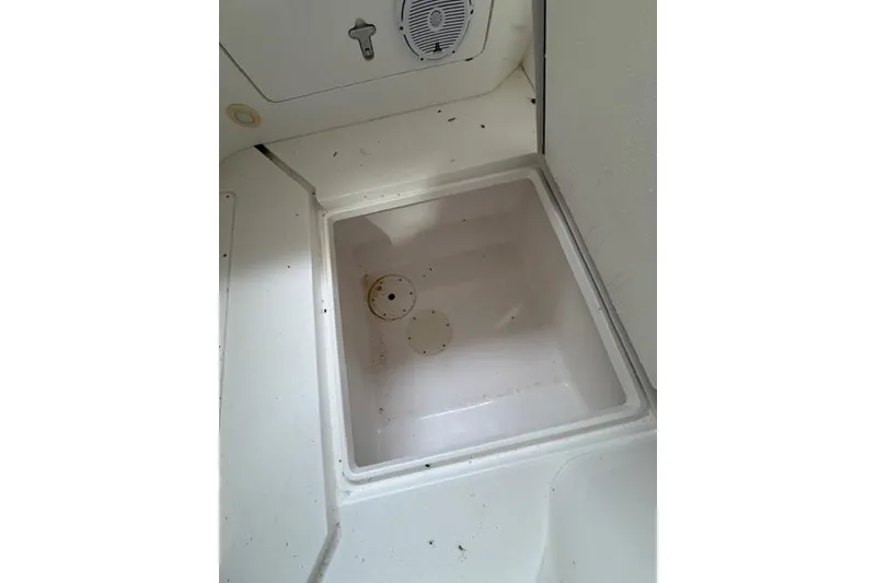 Slide: The Image of 2009 Intrepid 377 Walkaround boat storage compartment, white interior, open hatch. - 24