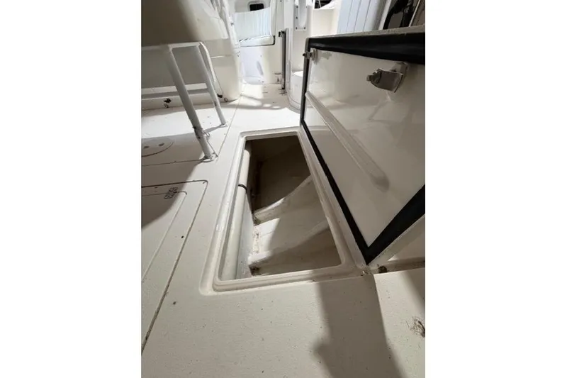 Slide: The Image of 2009 Intrepid 377 Walkaround boat interior storage compartment open. - 25