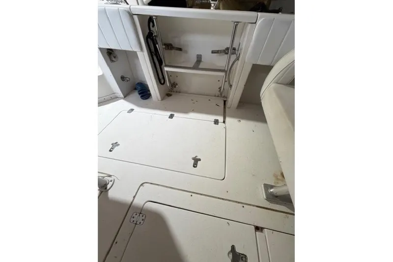 Slide: The Image of 2009 Intrepid 377 Walkaround boat interior with storage compartments and seating. - 26