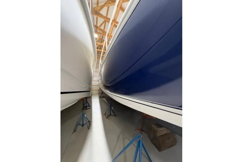 Slide: The Image of 2009 Intrepid 377 Walkaround boats in storage, blue and white hulls visible. - 3