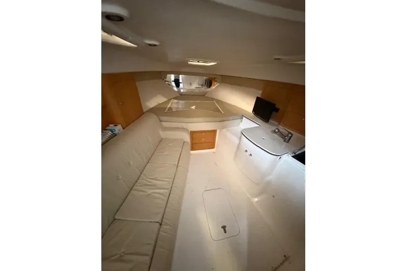 Slide: The Image of Interior of 2009 Intrepid 377 Walkaround boat with seating and compact kitchen area. - 30