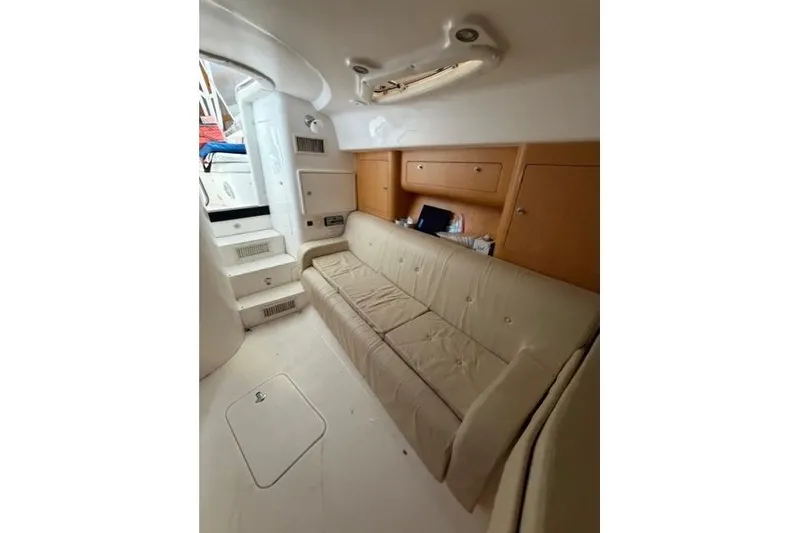Slide: The Image of 2009 Intrepid 377 Walkaround interior with beige seating and wooden cabinetry. - 31