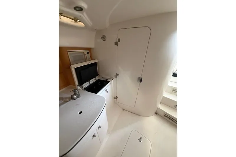 Slide: The Image of 2009 Intrepid 377 Walkaround interior with kitchenette, microwave, and storage. - 36