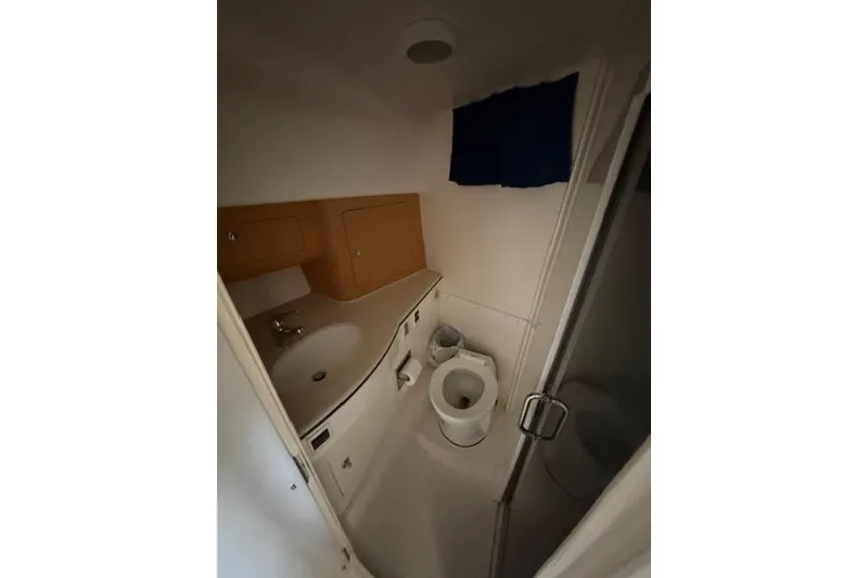 Slide: The Image of Bathroom interior of 2009 Intrepid 377 Walkaround boat, featuring sink and toilet. - 37
