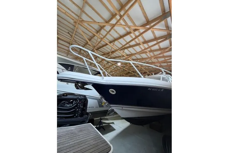 Slide: The Image of 2009 Intrepid 377 Walkaround boat in storage, showcasing sleek design and sturdy build. - 5