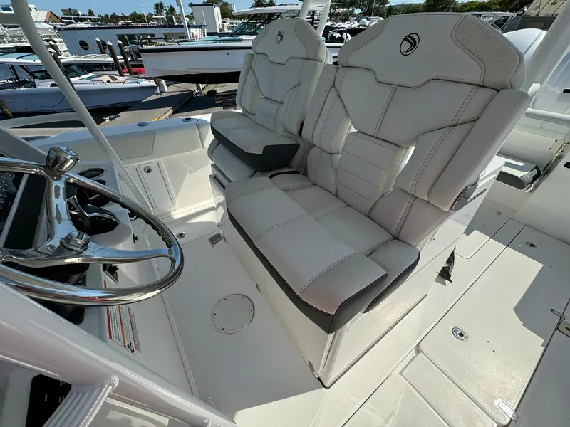 Slide: The Image of 2025 Edgewater 340CC boat interior with dual captain's seats and steering wheel. - 12