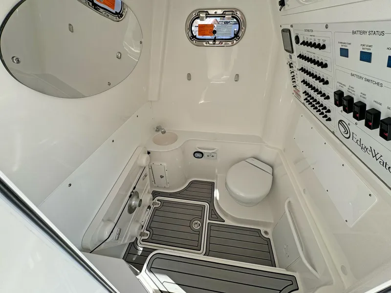 Slide: The Image of 2025 Edgewater 340CC boat interior with control panel, toilet, and sink. - 14