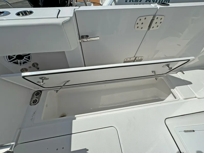 Slide: The Image of Open storage compartment on 2025 Edgewater 340CC boat, showcasing interior space and design. - 24