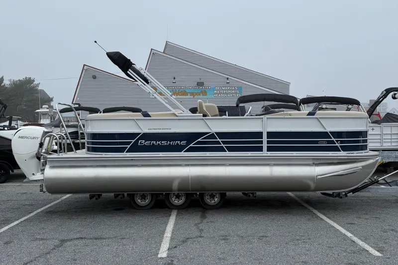 The Image of 2026 Berkshire 22RFX CTS pontoon boat with Mercury engine in parking lot. - 1