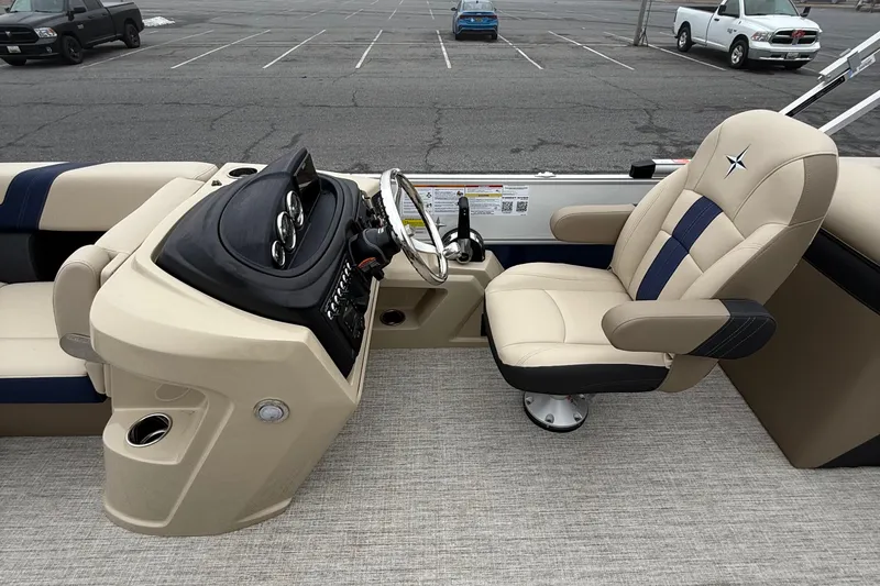 Slide: The Image of 2026 Berkshire 22RFX CTS boat interior with beige captain's chair and control panel. - 12