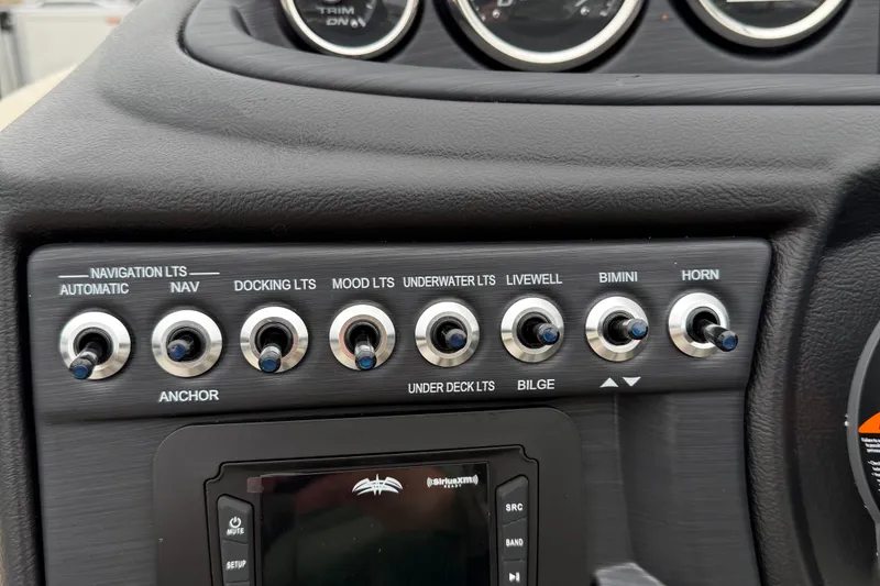 Slide: The Image of Control panel of 2026 Berkshire 22RFX CTS boat with various switches and gauges. - 14