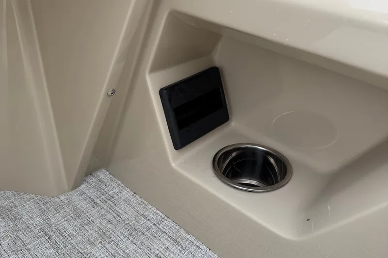 Slide: The Image of Interior detail of 2026 Berkshire 22RFX CTS boat with cup holder and storage compartment. - 16
