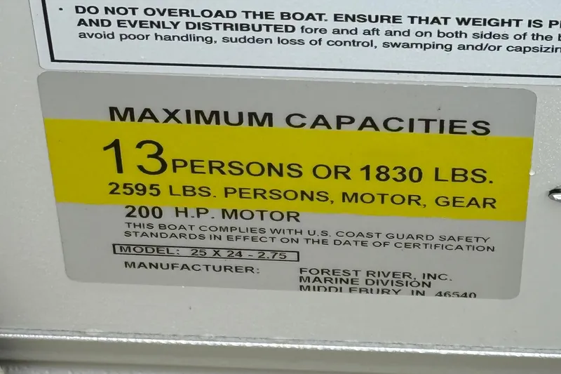 Slide: The Image of 2026 Berkshire 22RFX CTS boat capacity label: 13 persons or 1830 lbs, 200 HP motor. - 21