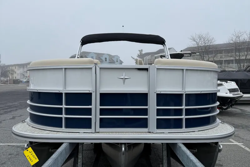 Slide: The Image of 2026 Berkshire 22RFX CTS pontoon boat on trailer in a foggy marina. - 3