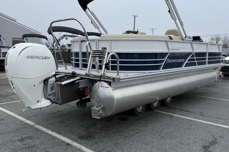 Slide: The Image of 2026 Berkshire 22RFX CTS pontoon boat with Mercury outboard motor in parking lot. - 8