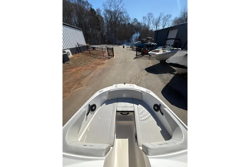 Slide: The Image of 2023 Sea Ray SPX 210 Outboard boat in outdoor storage area. - 12