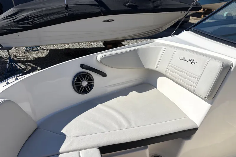 Slide: The Image of 2023 Sea Ray SPX 210 Outboard boat interior with white seating and speaker. - 14