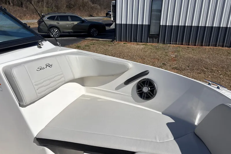 Slide: The Image of 2023 Sea Ray SPX 210 Outboard boat interior with white seating and speaker. - 15