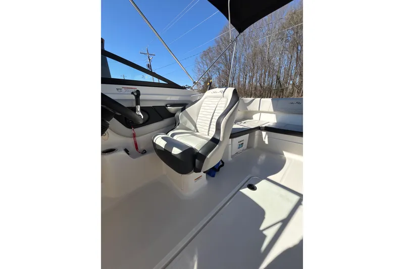 Slide: The Image of 2023 Sea Ray SPX 210 Outboard interior with helm seat and controls. - 17