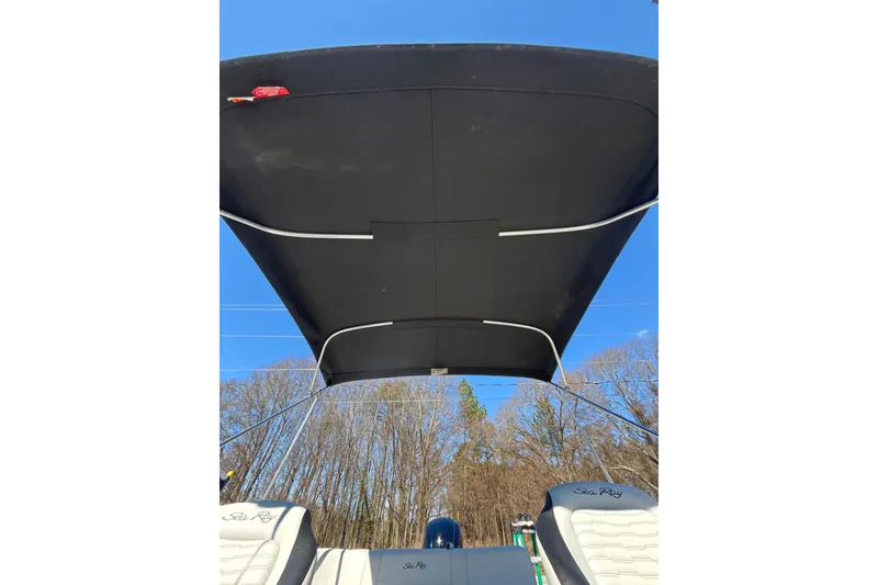 Slide: The Image of 2023 Sea Ray SPX 210 Outboard boat with canopy, clear blue sky background. - 19