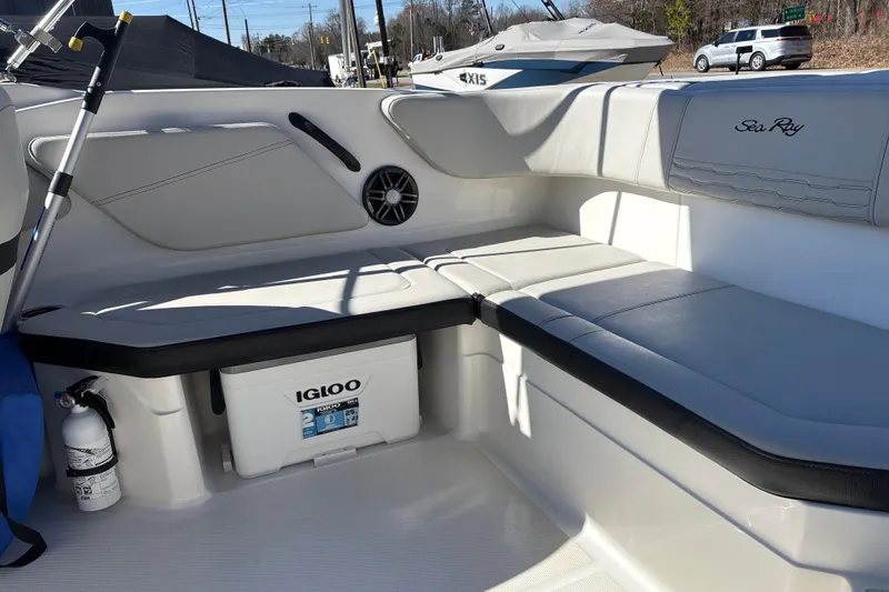 Slide: The Image of 2023 Sea Ray SPX 210 Outboard interior with seating, Igloo cooler, and fire extinguisher. - 22