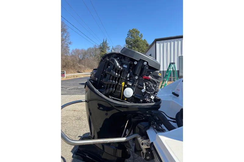 Slide: The Image of 2023 Sea Ray SPX 210 Outboard engine, detailed view under clear blue sky. - 26