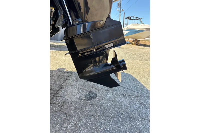 Slide: The Image of 2023 Sea Ray SPX 210 Outboard motor close-up on pavement. - 28