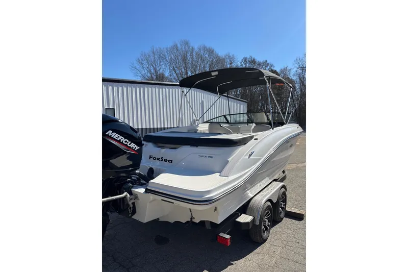 Slide: The Image of 2023 Sea Ray SPX 210 Outboard boat on trailer, featuring a Mercury engine. - 7