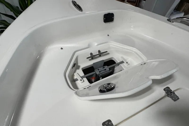 Slide: The Image of 2026 Key West 1720 Center Console boat anchor storage compartment open. - 14