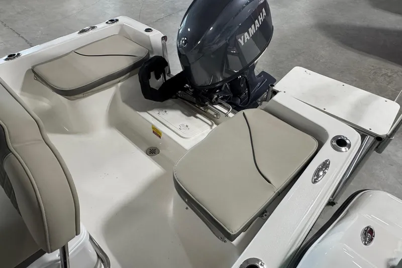 Slide: The Image of 2026 Key West 1720 Center Console boat interior with Yamaha engine, featuring cushioned seating. - 15