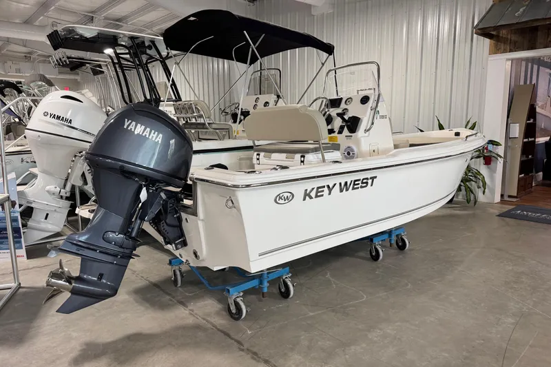 Slide: The Image of 2026 Key West 1720 Center Console boat with Yamaha outboard motor in showroom. - 2