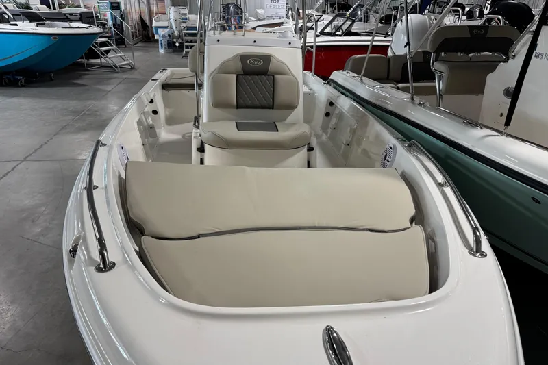 Slide: The Image of 2026 Key West 1720 Center Console boat with beige seating in showroom. - 3