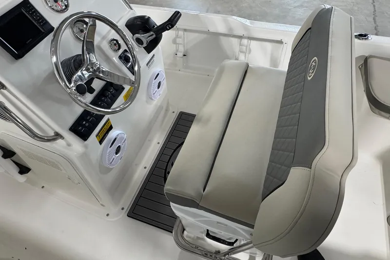 Slide: The Image of 2026 Key West 1720 Center Console boat interior with steering wheel and seating. - 8