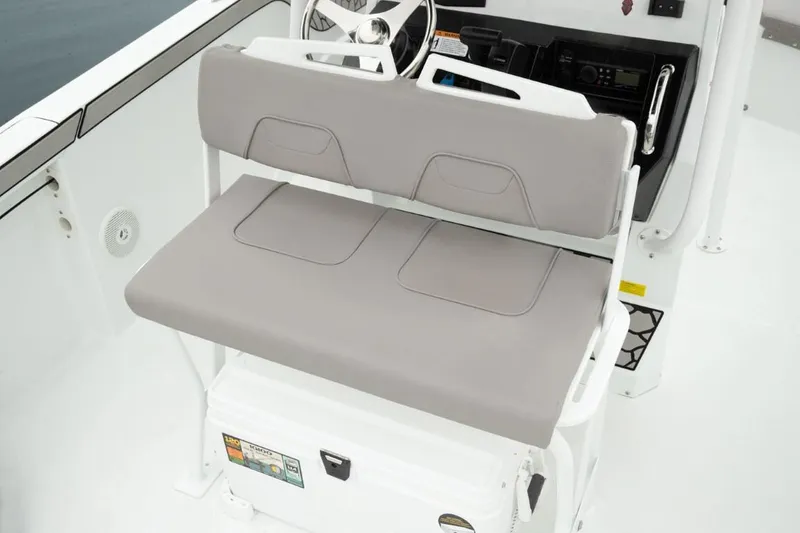 Slide: The Image of 2024 Wellcraft 202 Fisherman boat interior with cushioned seating and steering console. - 13