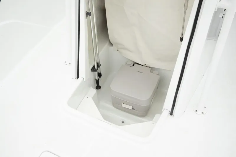 Slide: The Image of Portable toilet in the 2024 Wellcraft 202 Fisherman boat. - 22