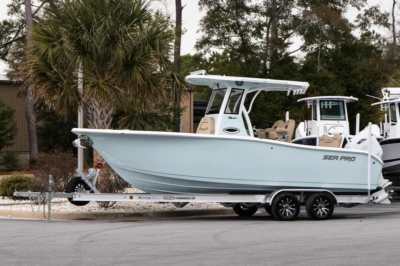 The Image of 2026 Sea Pro 245FLXR Sandbar boat on trailer, parked outdoors. - 1
